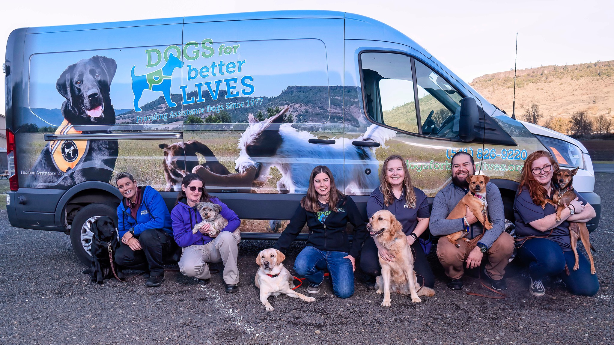 Dogs for Better Lives standing outside of vehicle